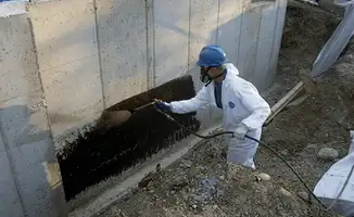 Professional waterproofing the exterior walls of the basement in Pembroke Pines, FL