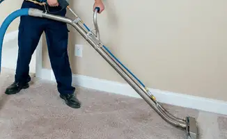 Professional operating a liquid removal machine on a carpeted floor in Pembroke Pines, FL